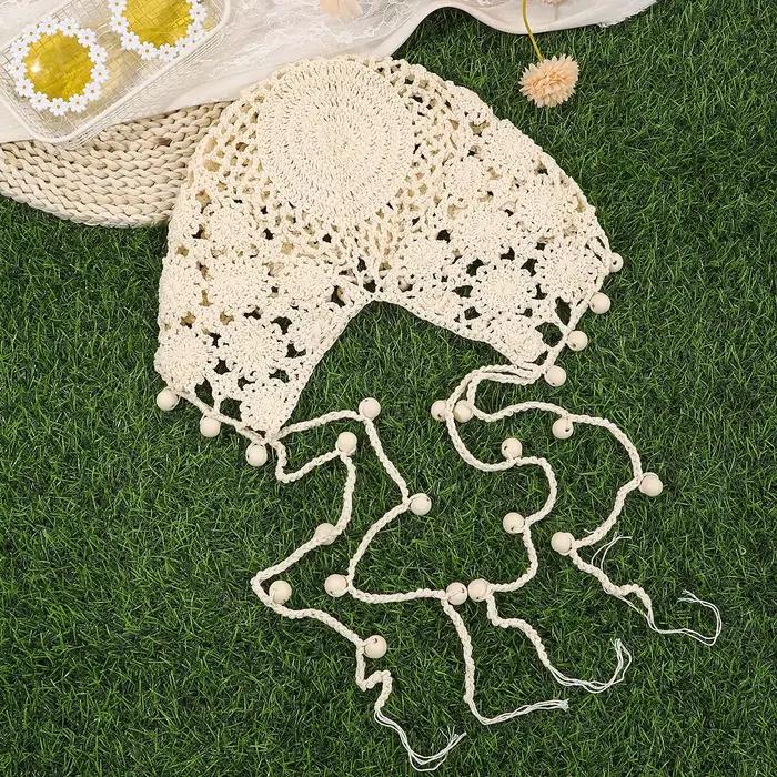 Bonnet tricoté ajouré à fleurs au crochet et à pompons perlés